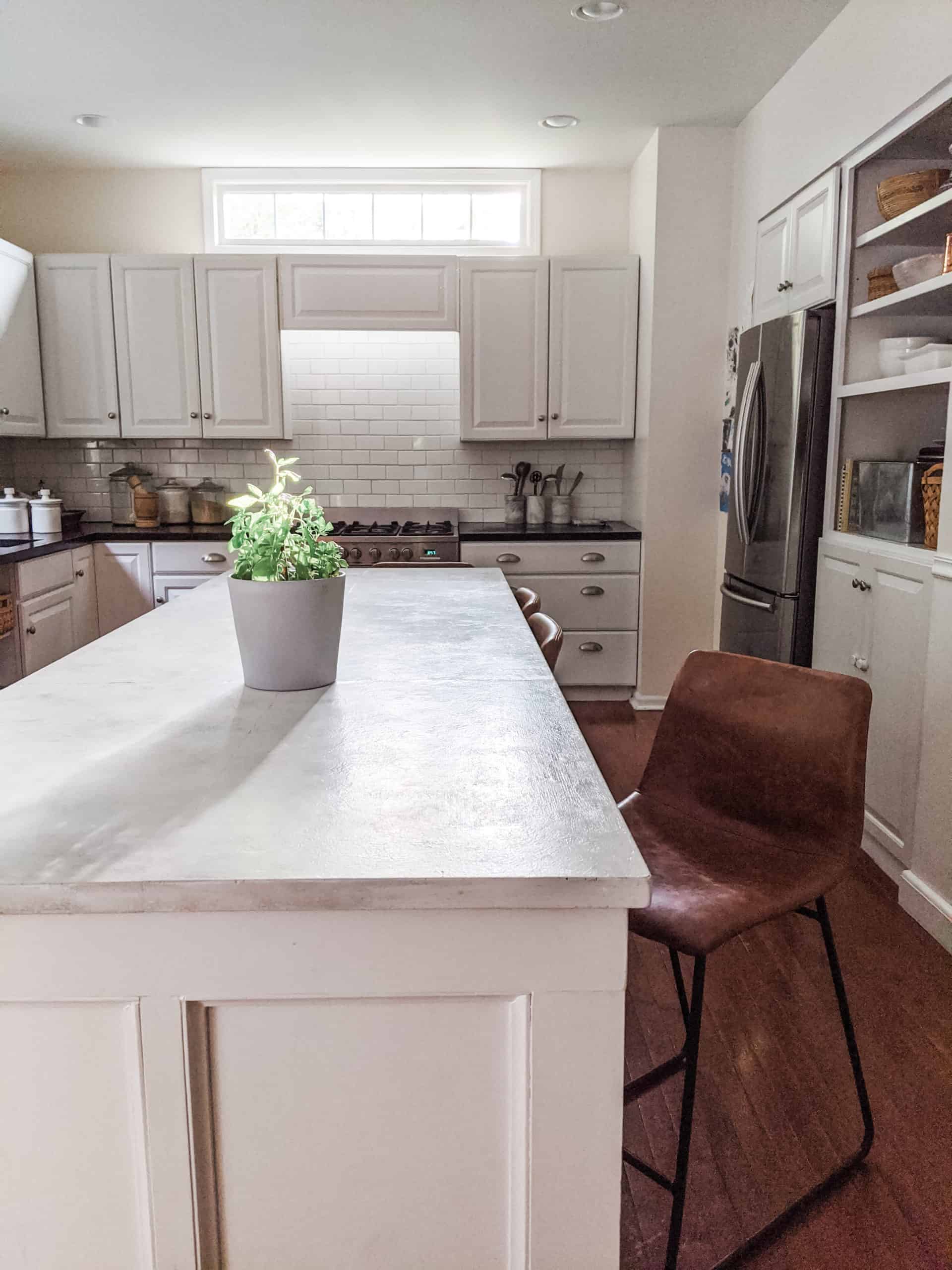 A traditional, large white kitchen island 
