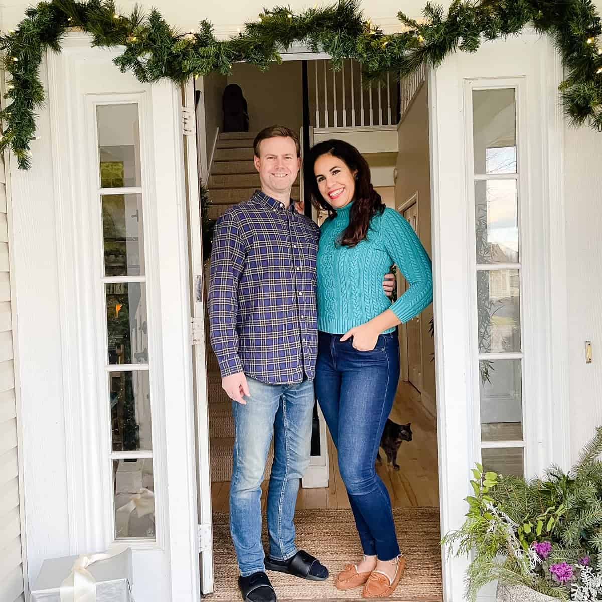 couple standing on Christmas front porch