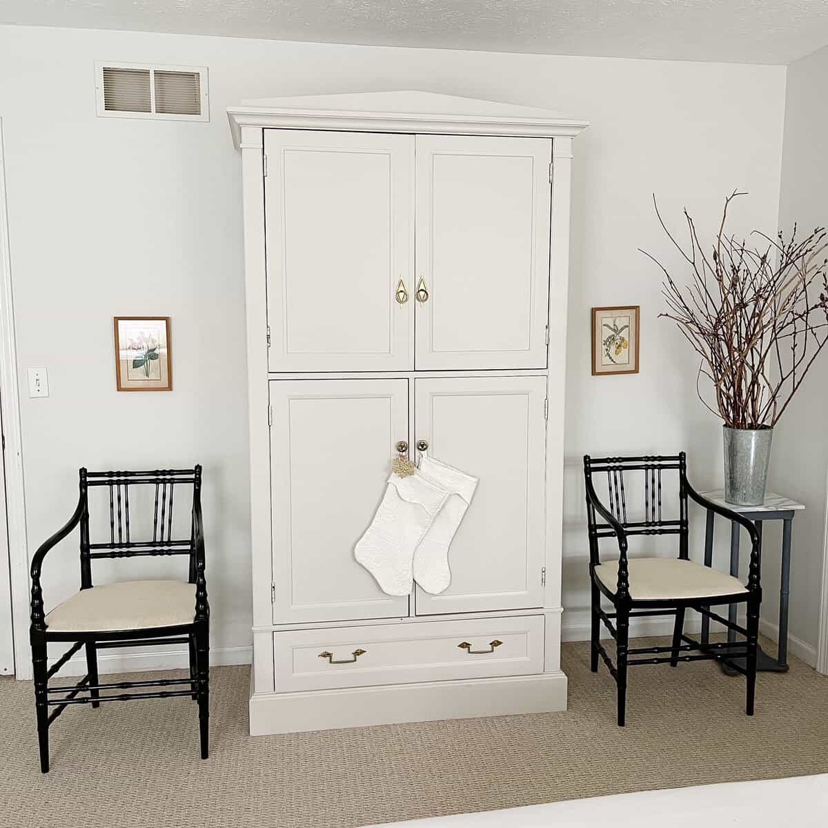 white armoire black chairs