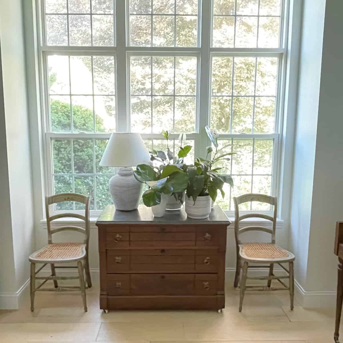 two chairs next to a big window