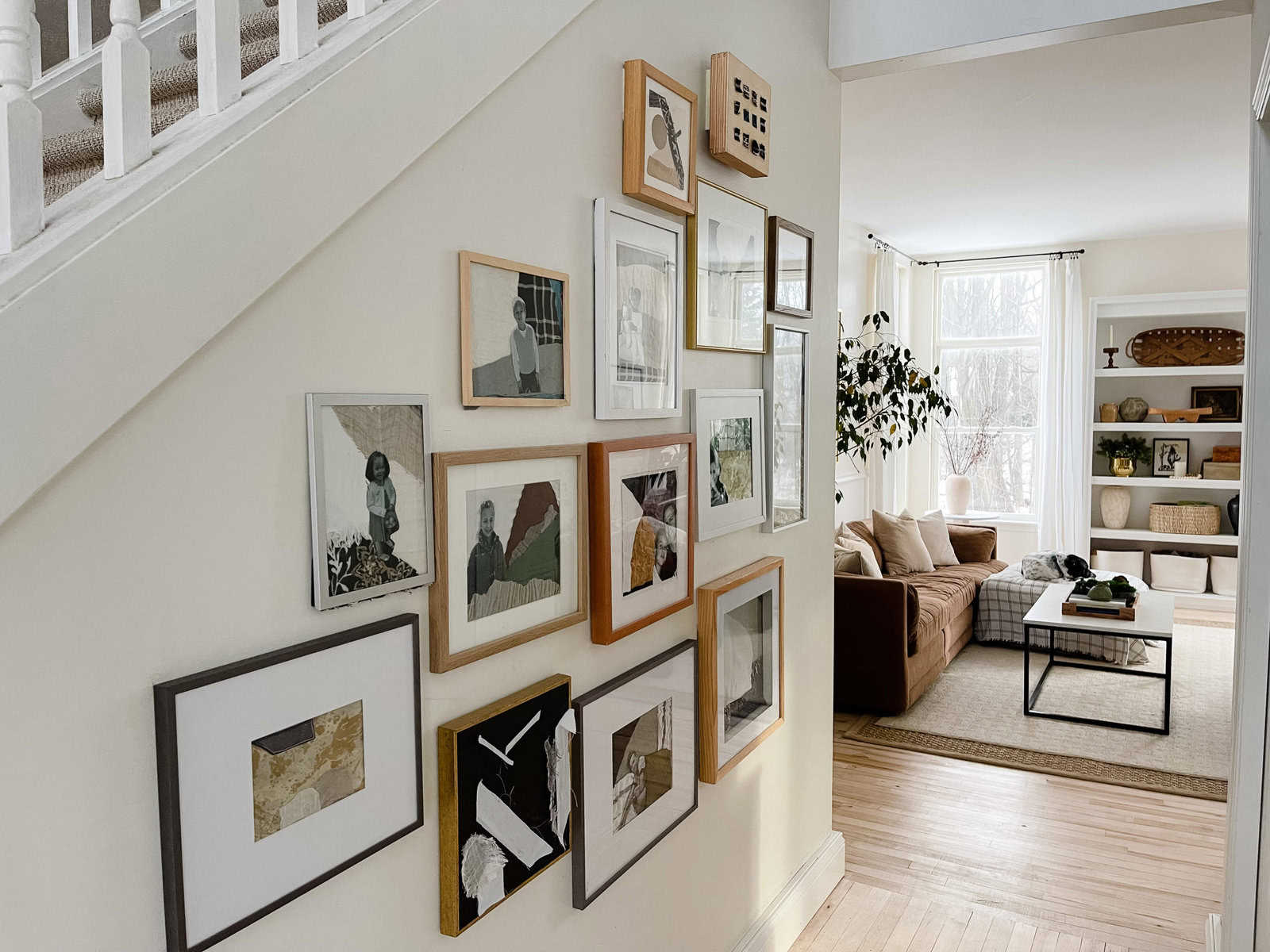A hallway in a home with a photo gallery wall.