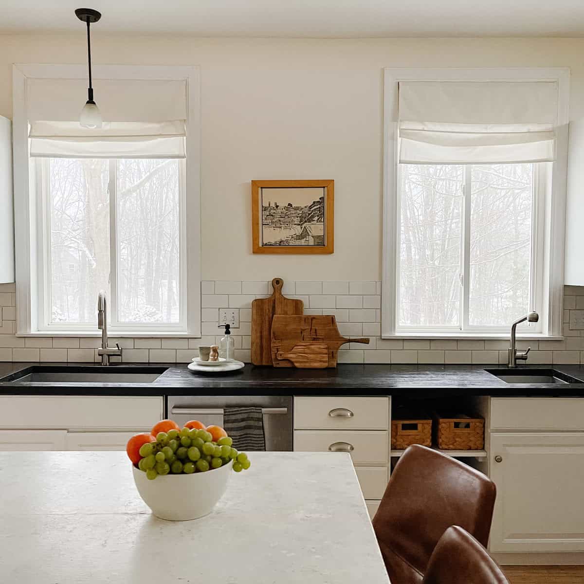 A black and white kitchen with two sinks 
