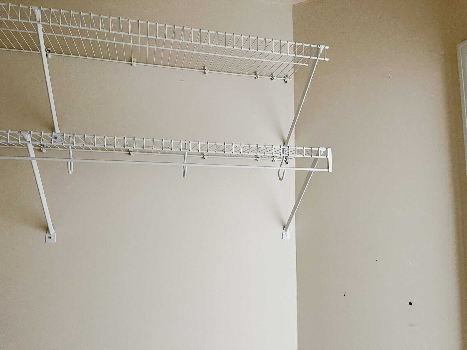 white wire closet shelves against a cream colored wall