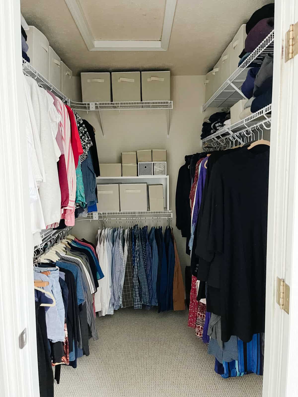 walk in closet organized with boxes and hangers