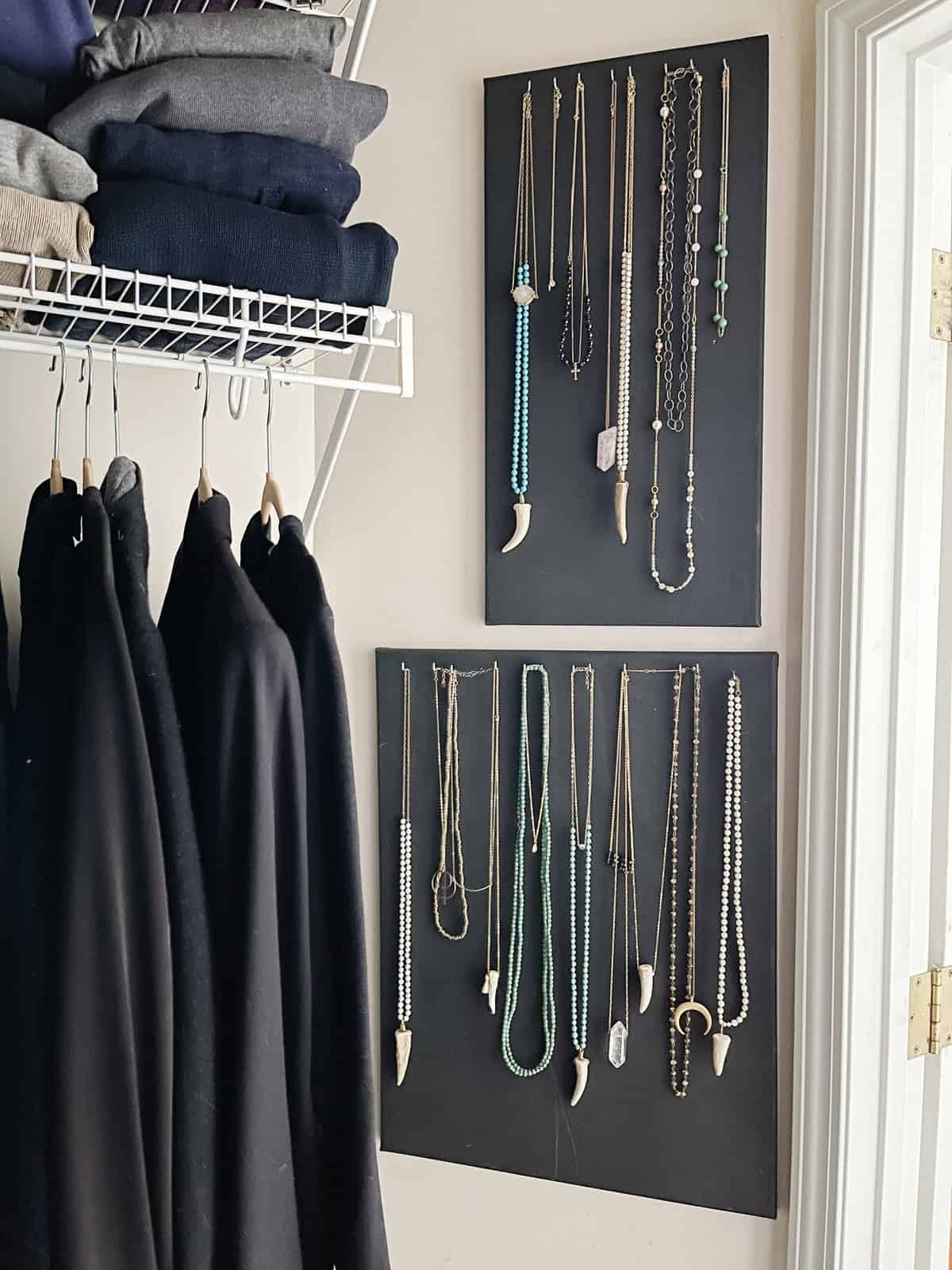 necklaces hanging organized on canvas boards in closet