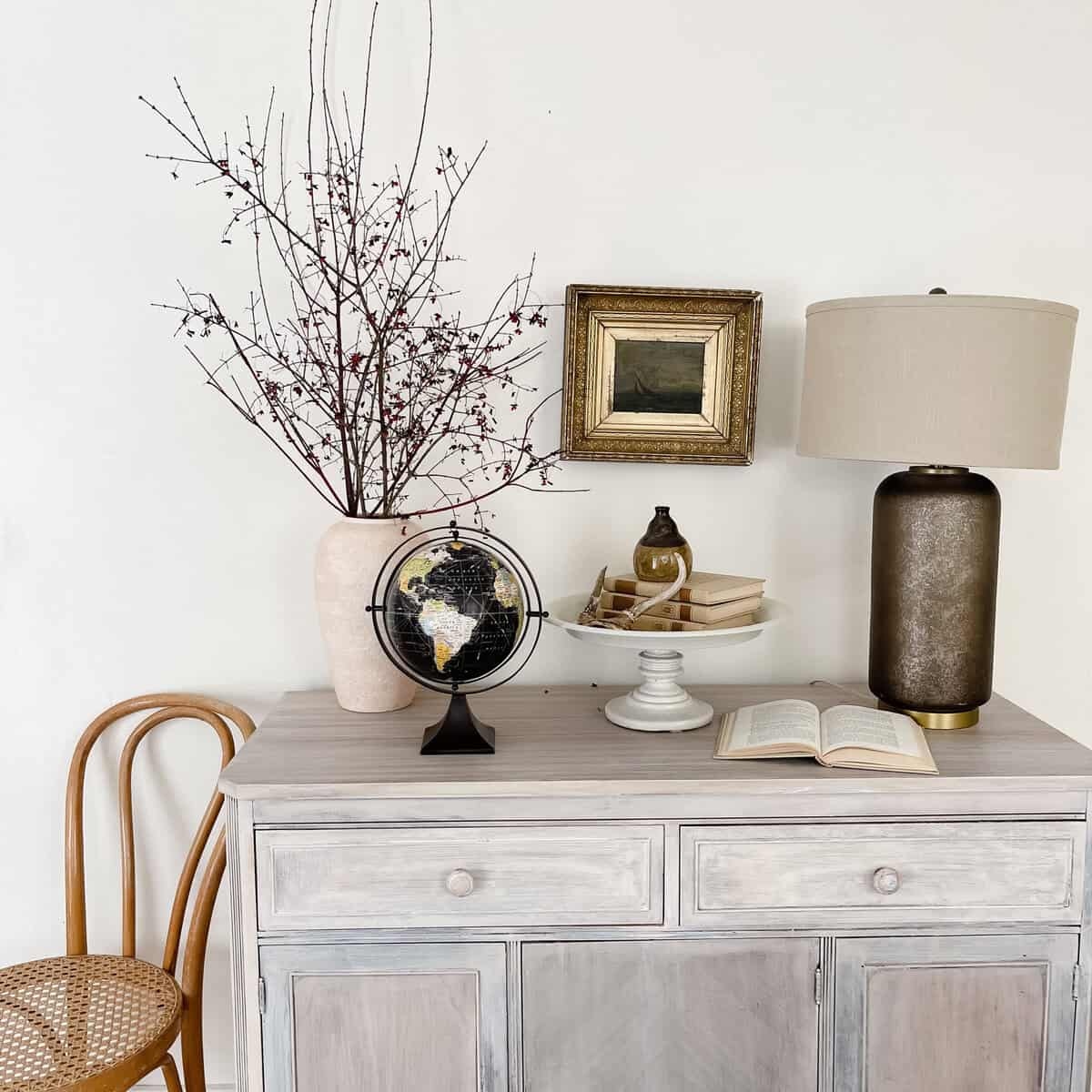 buffet dresser styled with world globe and neutral home decor