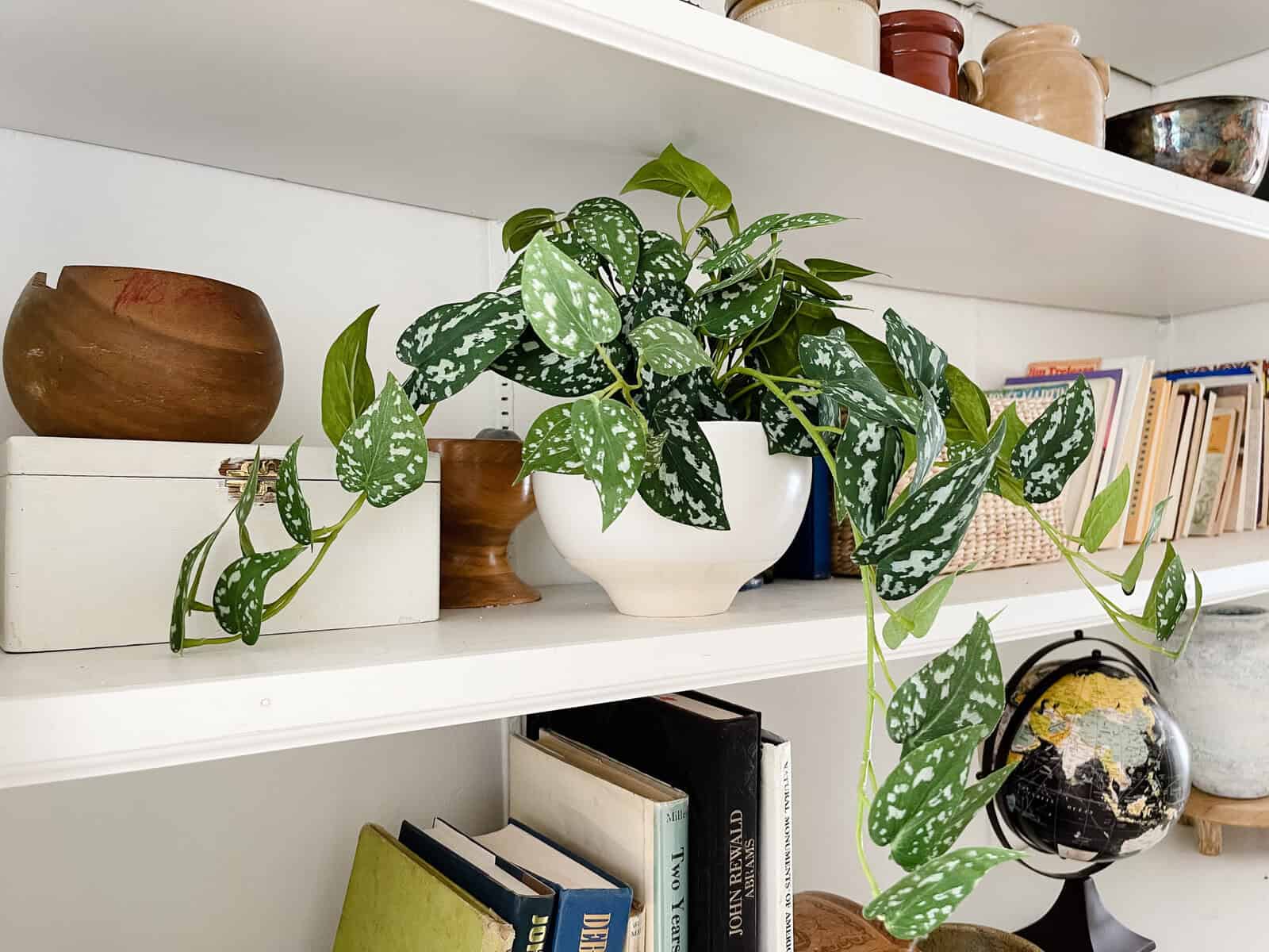 faux plant styled on shelf in home interior