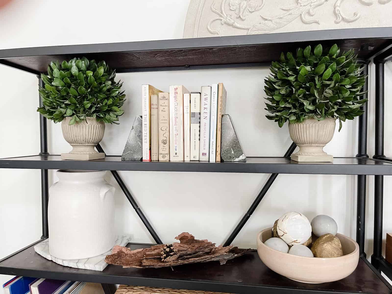 two faux boxwood plants in gray vintage pots