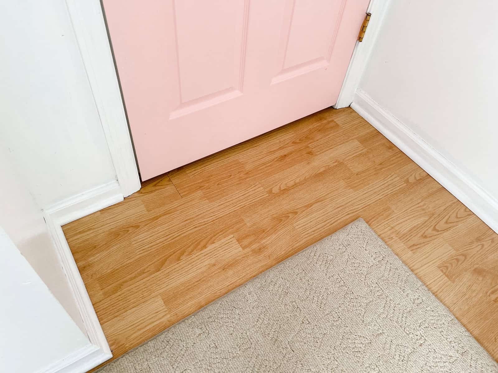 oatmeal carpet next to pink door