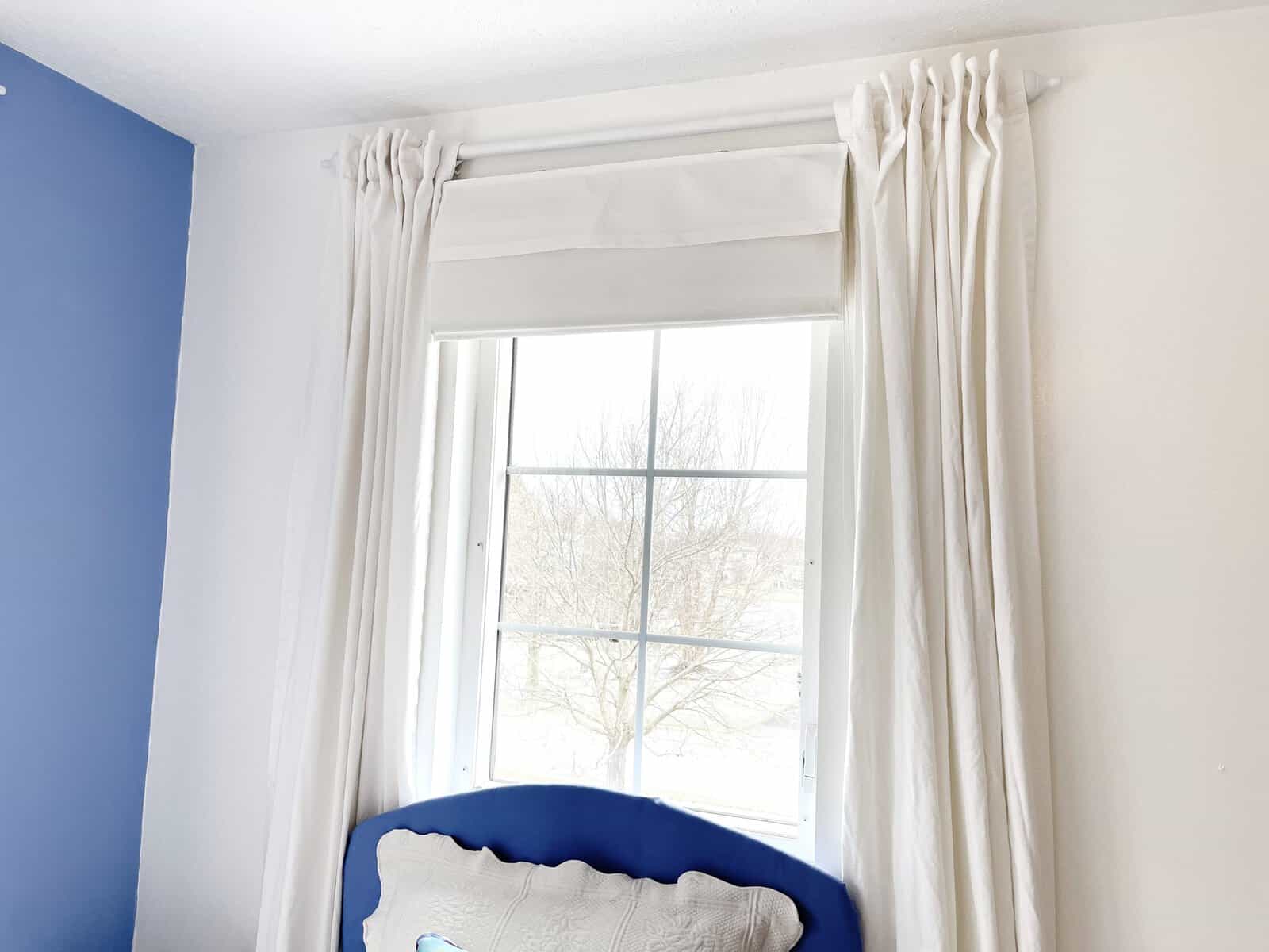 bedroom window with white curtains
