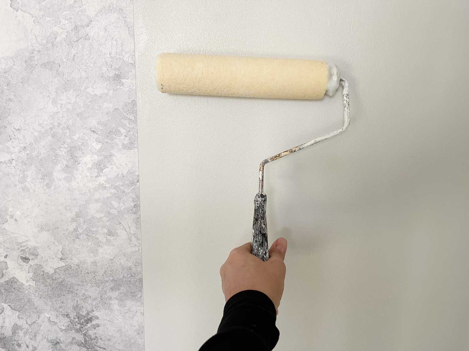 rolling wallpaper glue on wall