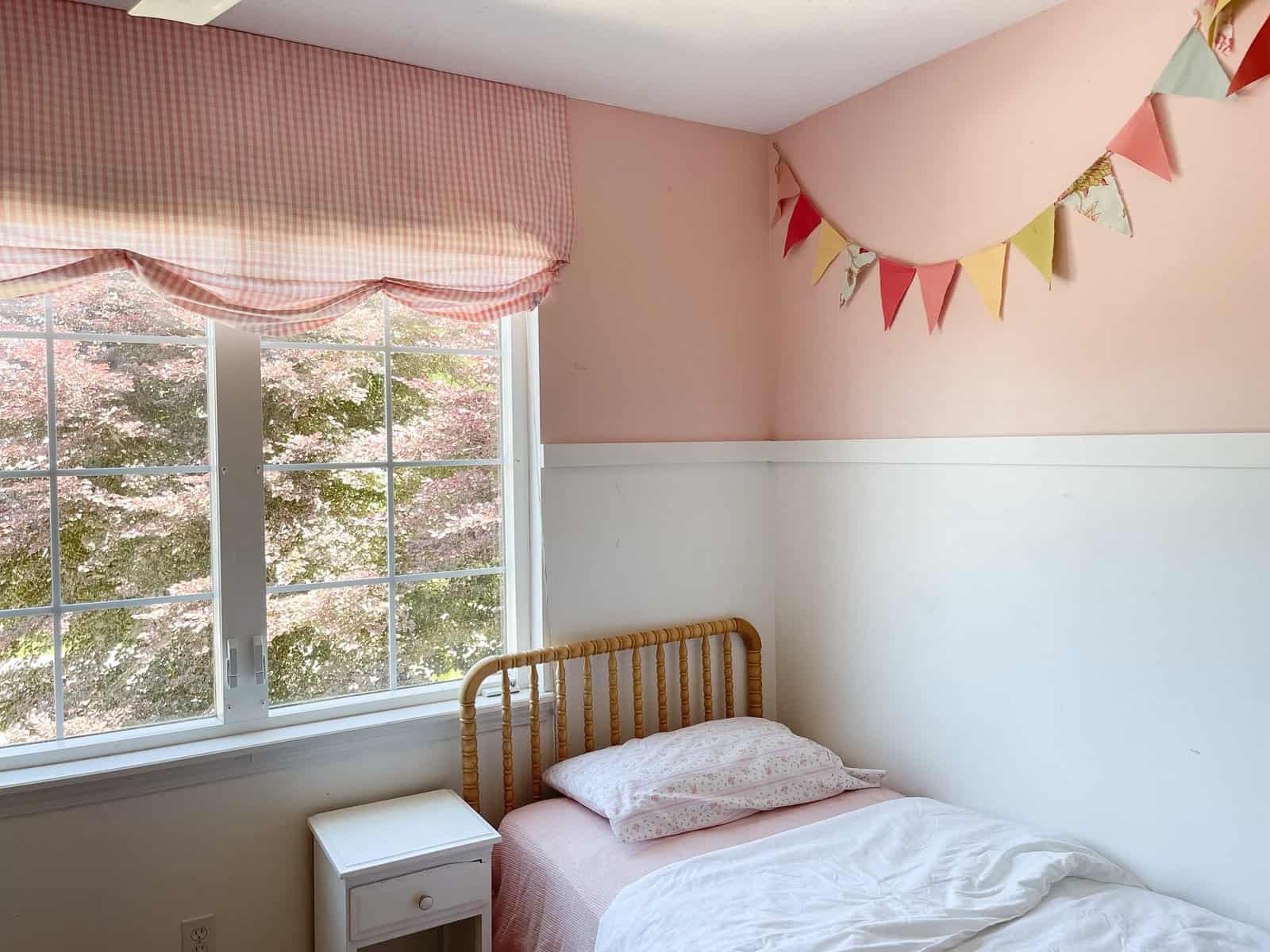 Country style pink and white bedroom with banner