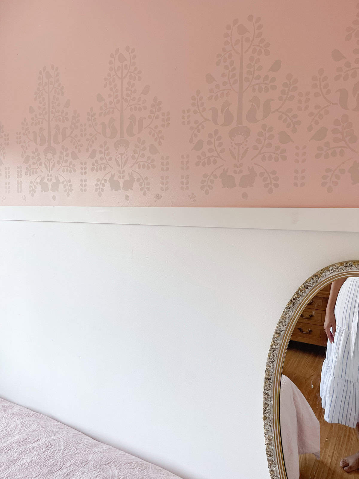 pink and white bedroom with stenciled wall