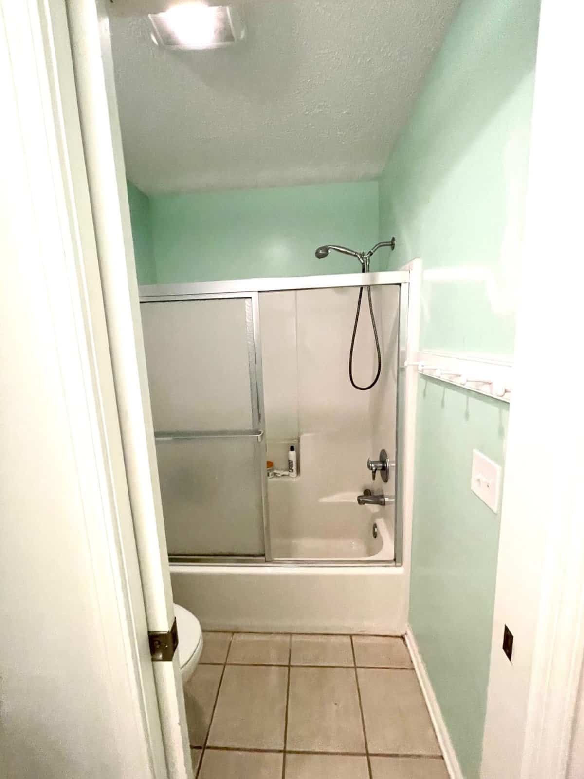 Replacing a Dated Glass Shower Door with a Double Rod and Curtains